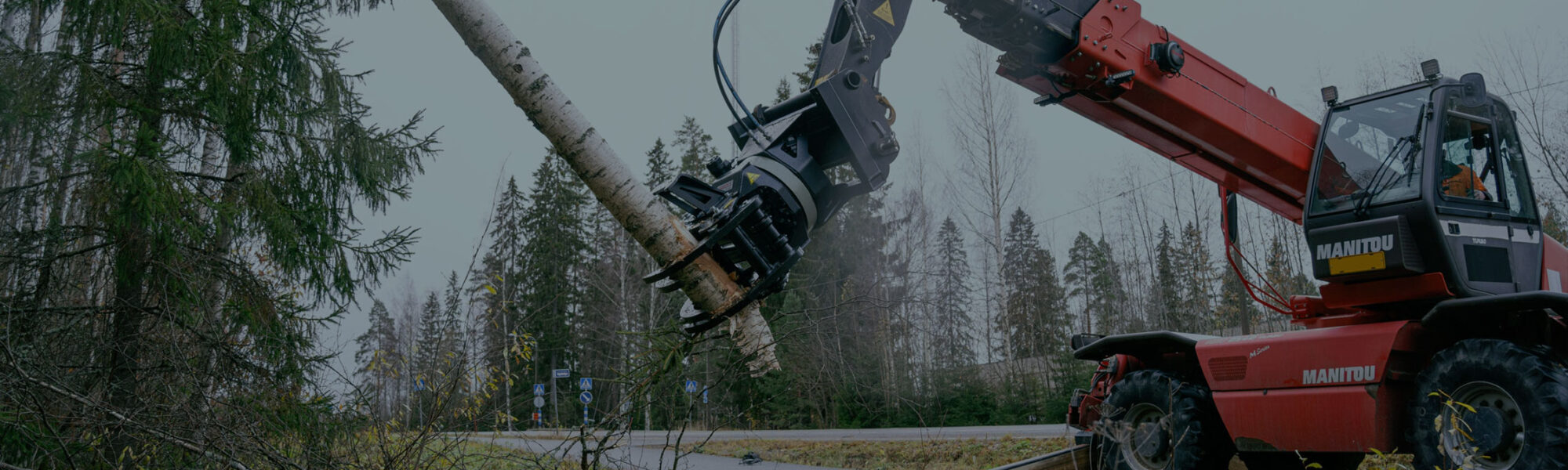 JAK-300R energiakoura kiinnitettynä kurottajaan, pitämässä kiinni isosta puunrungosta.